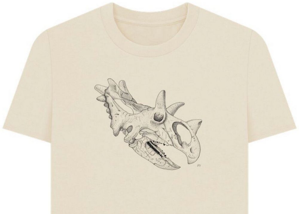 cream shirt with a line and dot shading drawing of a ceratops skull.