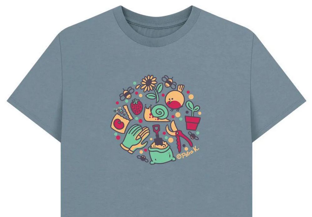 light blue grey t-shirt with a plethora of little gardening themes in a circle, in black, red, yellow, mint green. bees, sunflower, snail, gloves, a satched of tomato seeds, flies, a bag of dirt with a shovel, garden shears, a potted seedling, a robin. 