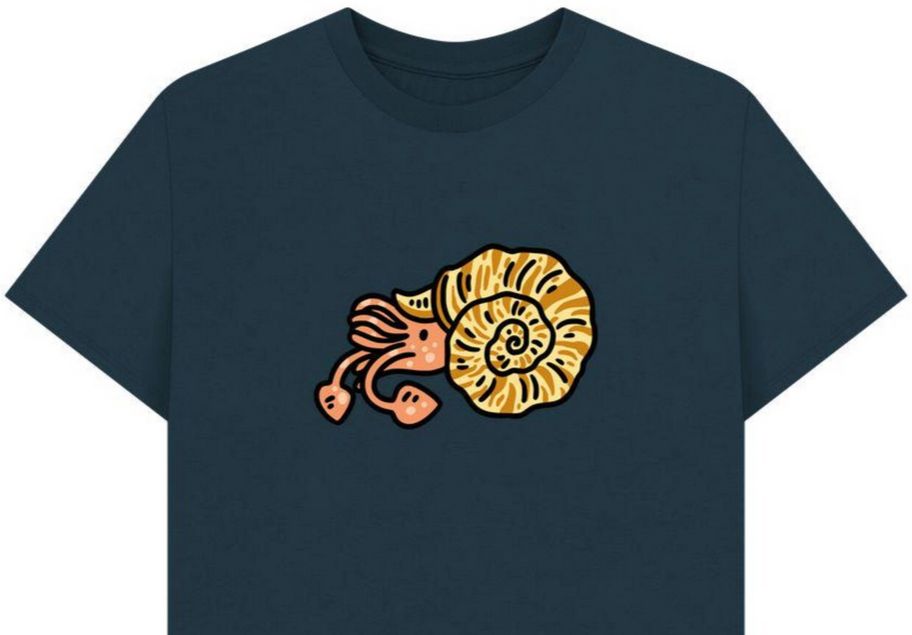 dark blue t-shirt with a silly comic ammonite drawing, the ammonite is peach pink with a yellow orange stripey shell.