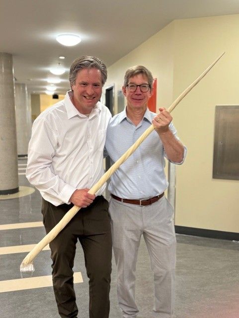 Bill and Eric holding a narwhal tusk