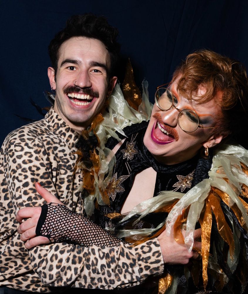 portrait pic of me and Carrot laughing together; Carrot is in full drag, and i'm in a leopard print shirt