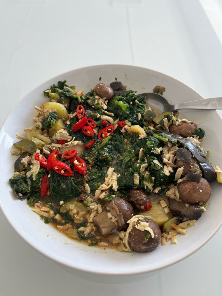 Teller mit Spinat, Pilzen? Zucchini, Auberginen, Räuchertofo geraspelt und viel Chili. Gewürzt mit Misopaste und Limettensaft.