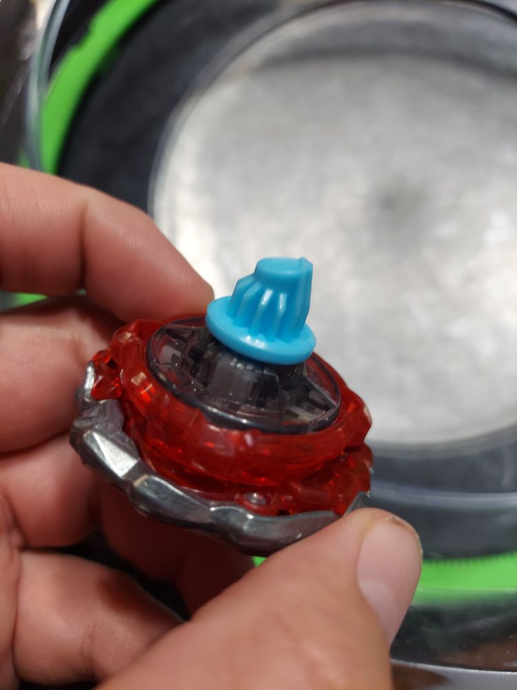 Beat Tyranno flipped upside down to show the Quake bit. It has an uneven surface and a flat protrusion.