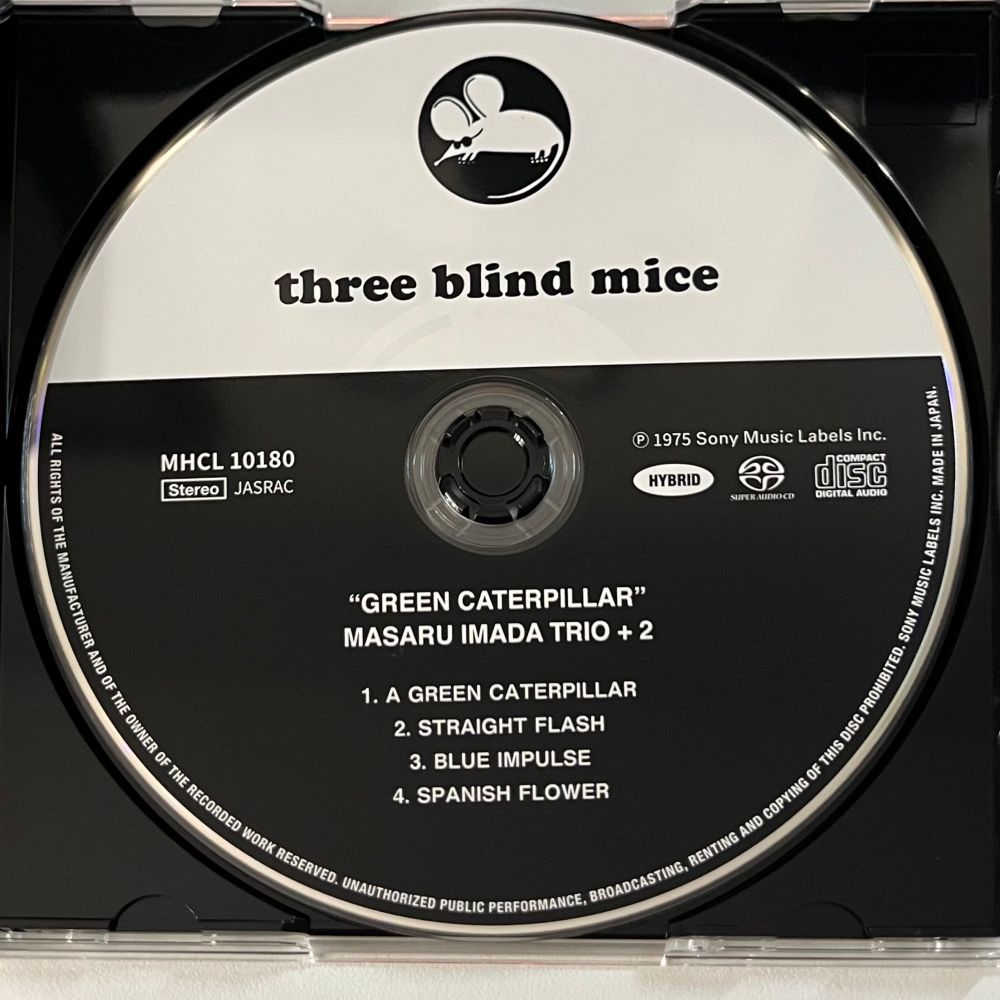 Black and white face of a CD with the Three Blind Mice logo in black against a white background on top and the album info in white typeface against a black background on the bottom.
