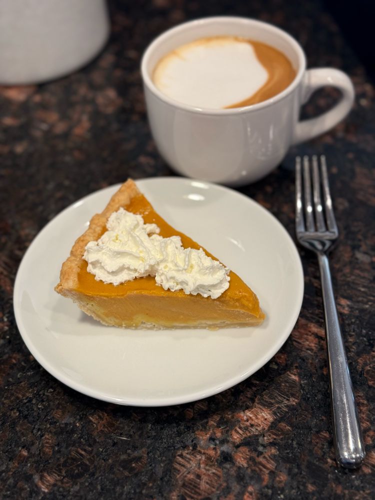 Pumpkin pie with a cup of coffee