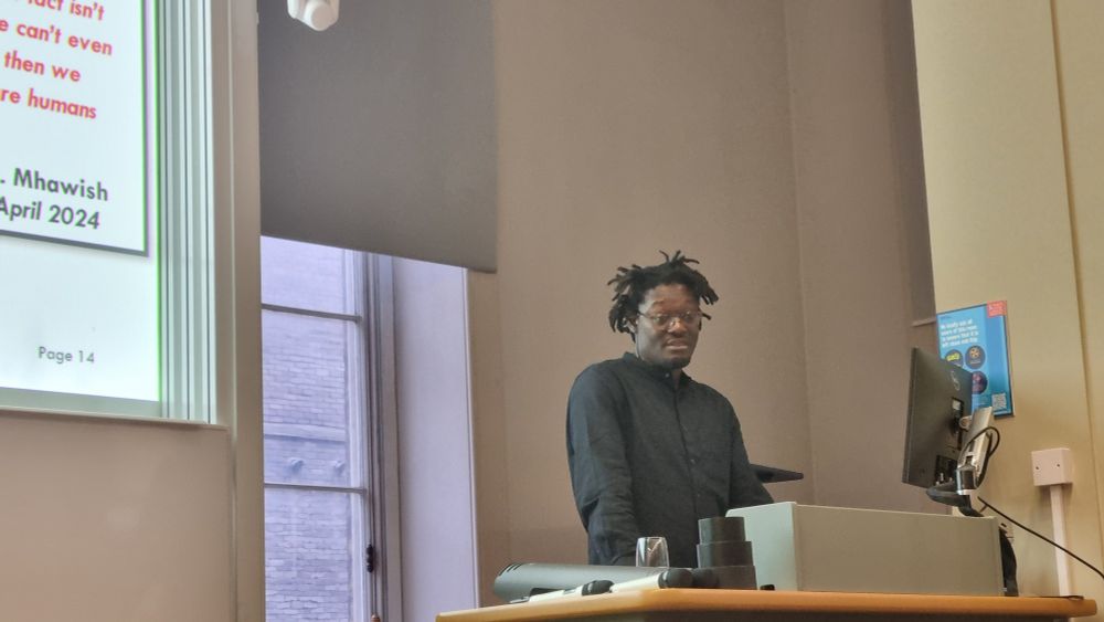 Seye Abibola speaks from a lectern