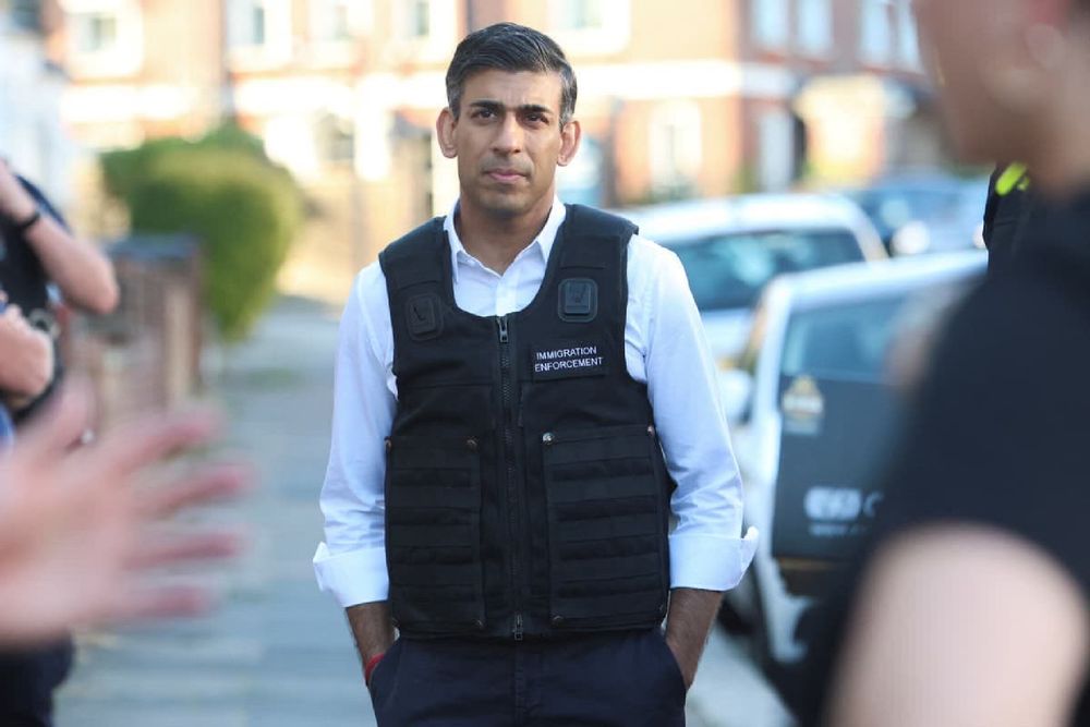 Rishi Sunak wearing a tactical “immigration enforcement” vest