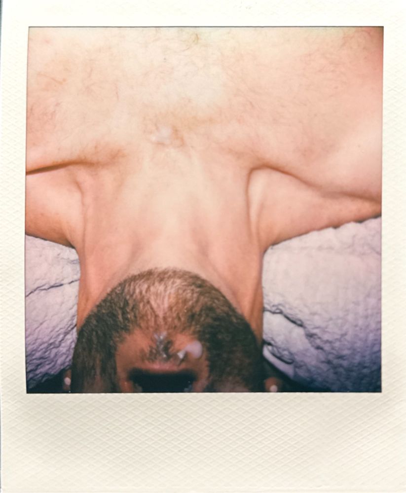 A Polaroid picture of man’s beard with cum on it 