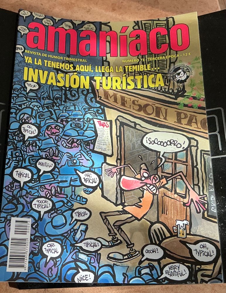 A picture of the cover of the Spanish magazine Amaniaco, it shows a local man from a Spanish town being surrounded by a hoard of tourists