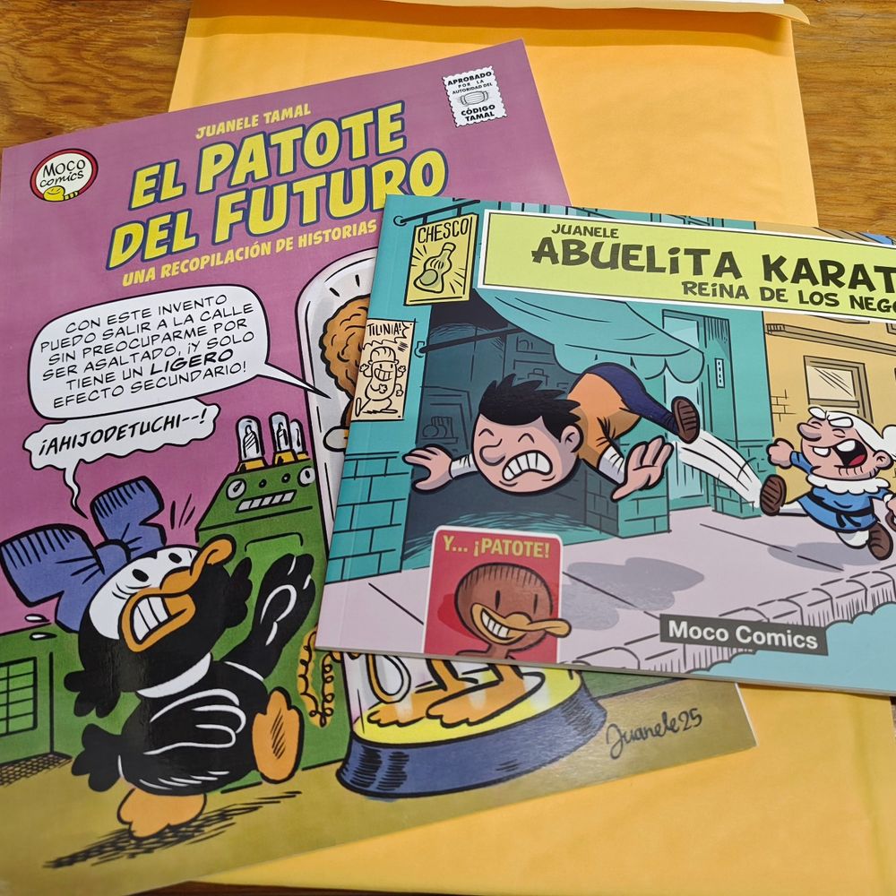 A picture of two of my comics and a yellow envelope, ready to be send by mail to a reader. 