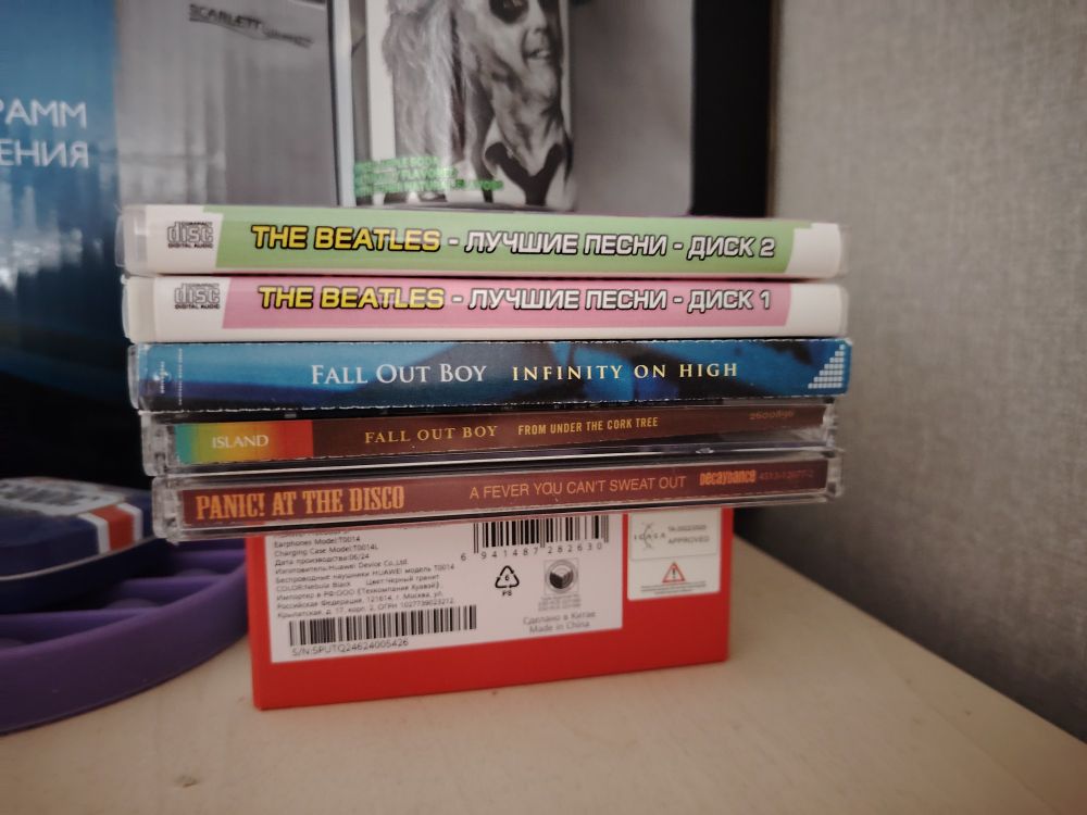 A picture of my compact disks. In order from down to up (which is also the chronological order!) : A Fever You Can't Sweat Out by Panic! At The Disco, From Under the Cork Tree by Fall Out Boy, Infinity on High by Fall Out Boy, The Beatles greatest hits disk 1 and 2