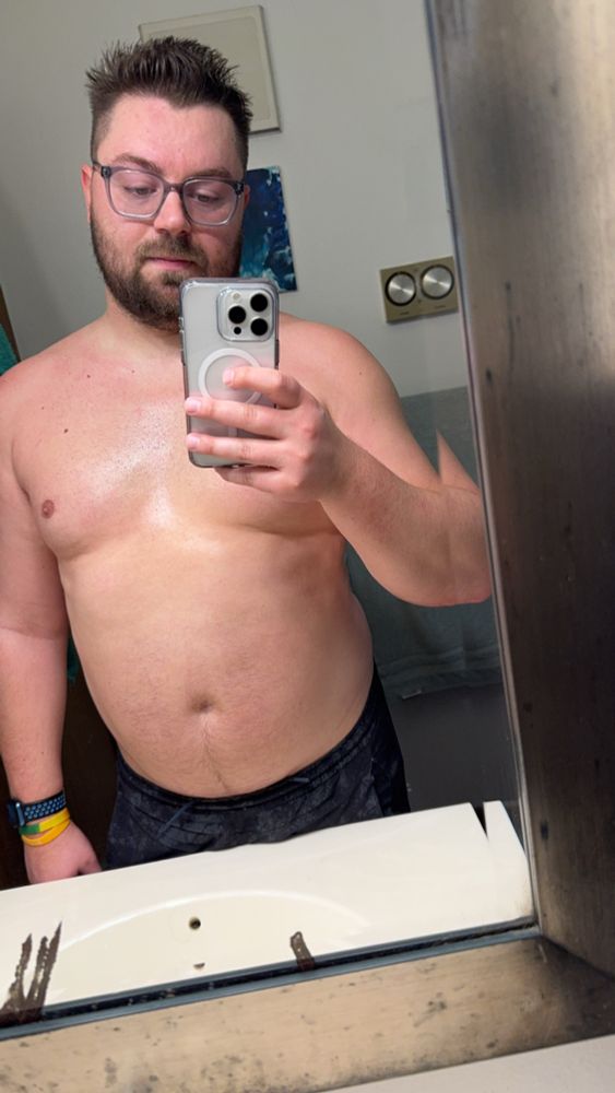 Me standing in the mirror with short on, very sweaty 