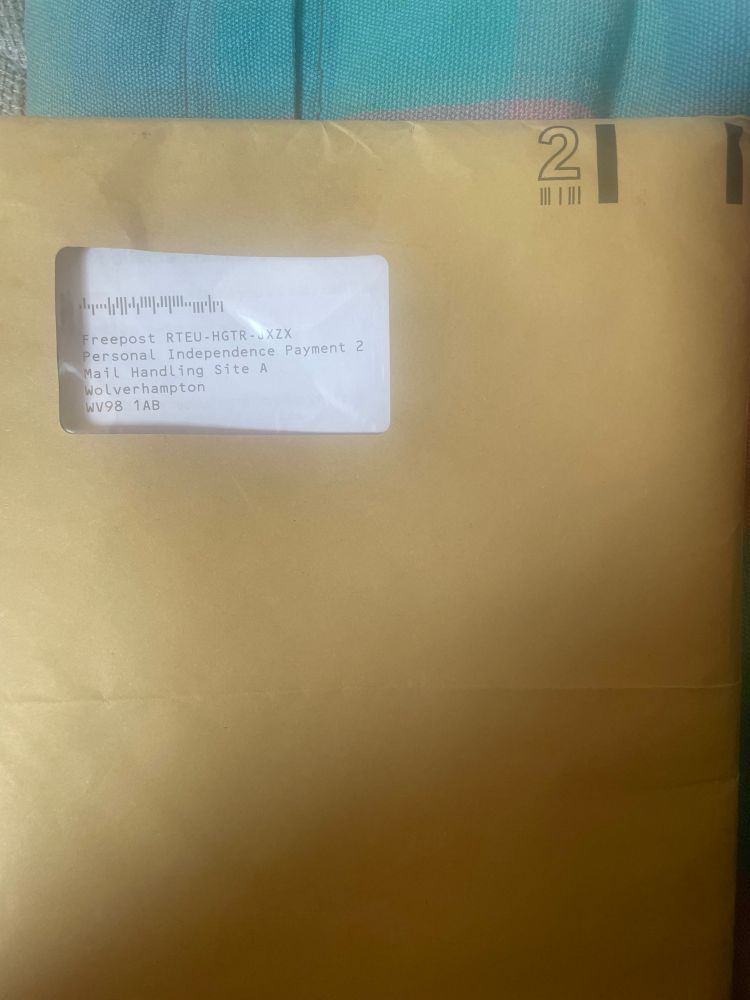 Photo showing a brown A4 envelope, in the clear window of the envelope is the freepost address for returning completed Personal Independence Payment forms 
