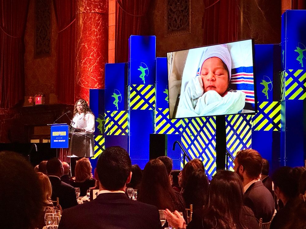 Picture of a speaker with a tv screen showing a baby