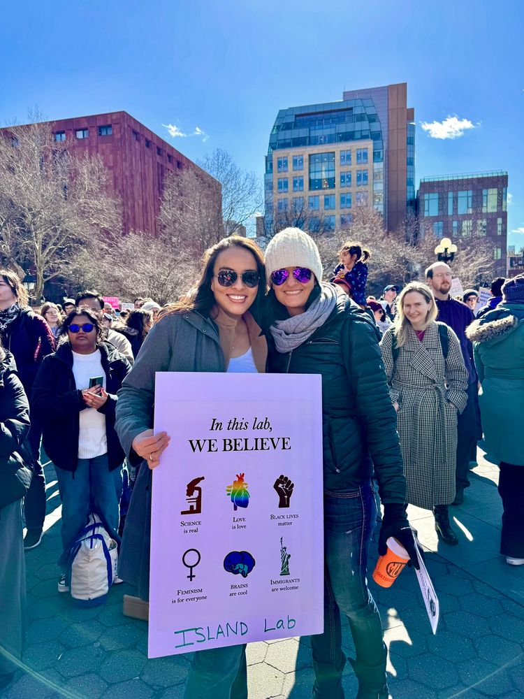 Two scientists holding up sign at rally