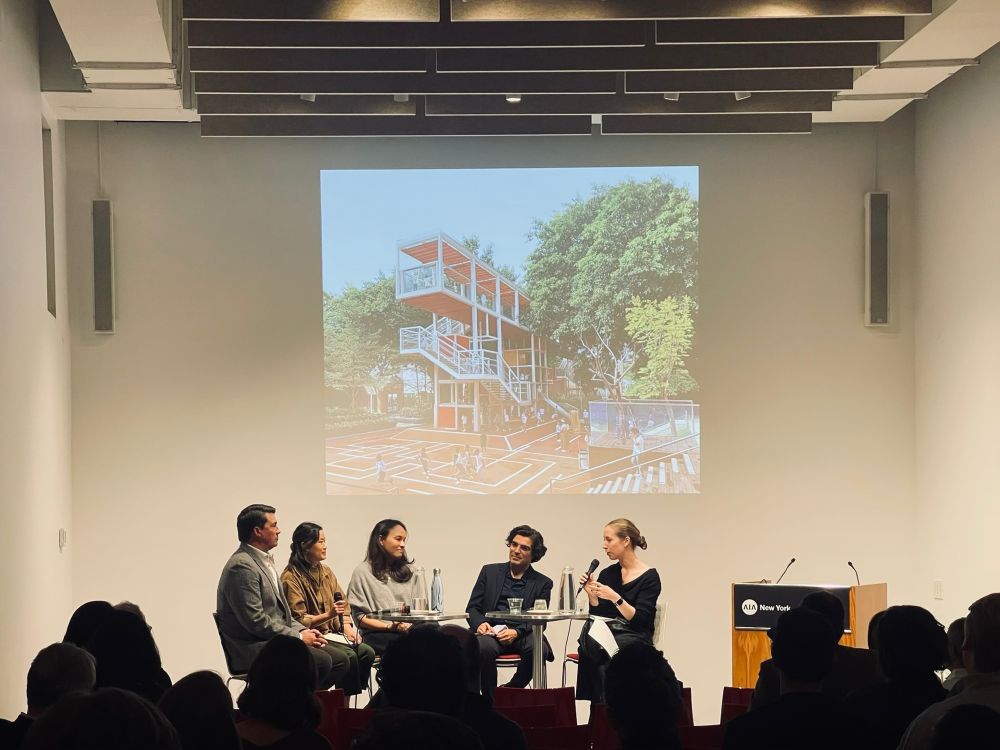 Panelists sitting in front of an audience 