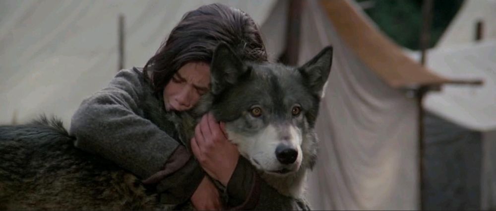 Natty Gan embraces her pet wolf from the movie The Journey Of Natty Gan