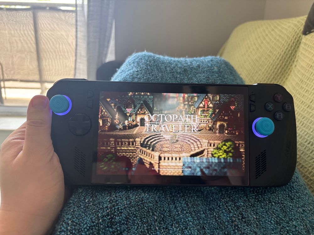 Holding an ROG Ally X on my lap playing Octopath Traveler