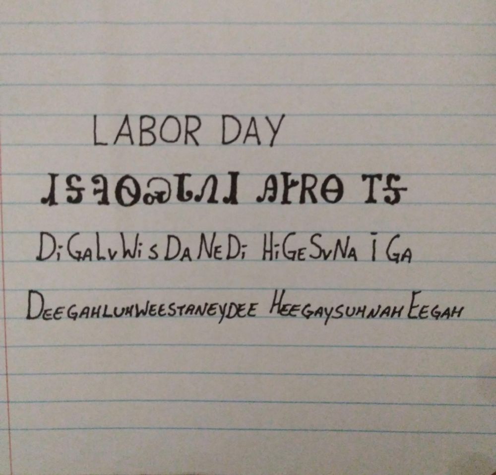 Image is line paper with writing showing an English word followed by how it is written in the Cherokee language followed by how it is spelled and pronounced. The word is labor day and pronounced deegahluhweestaneydee heegaysuhnah eegah