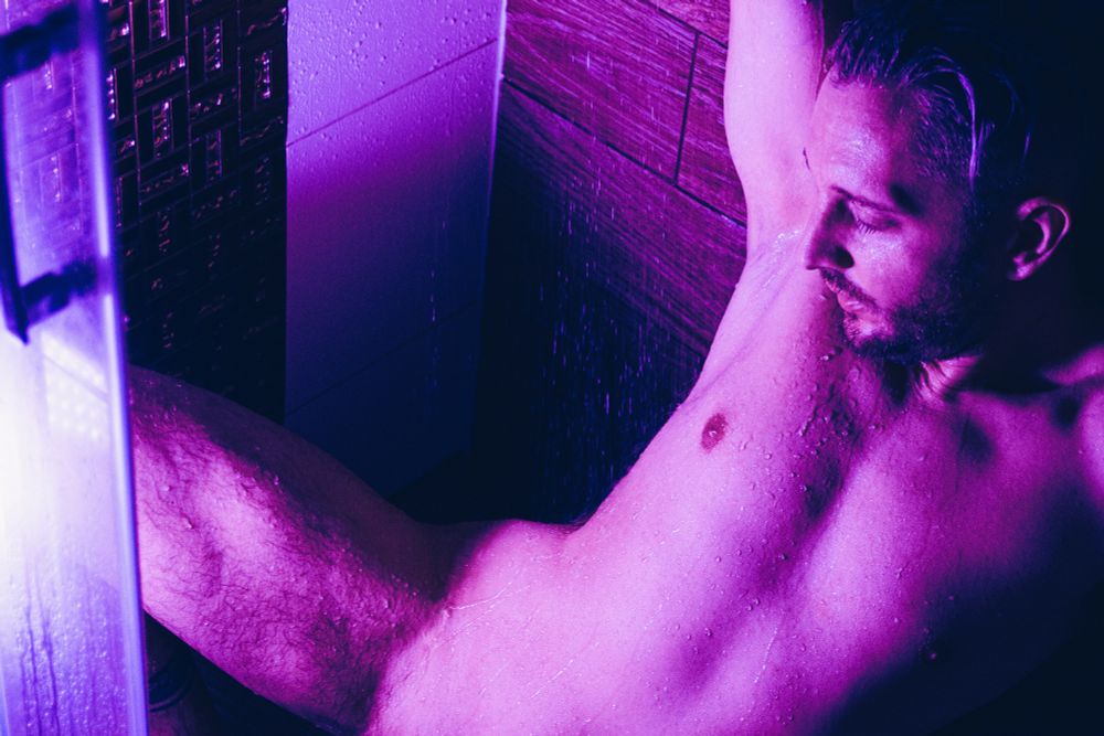 nude posing under the shower and purple lights, male gay sensual fantasy