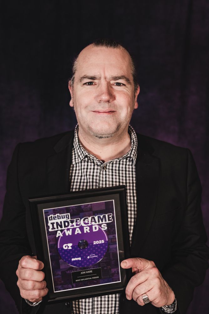 Jon Hare with the Most Influential Person award at the Debug Indie Game Awards