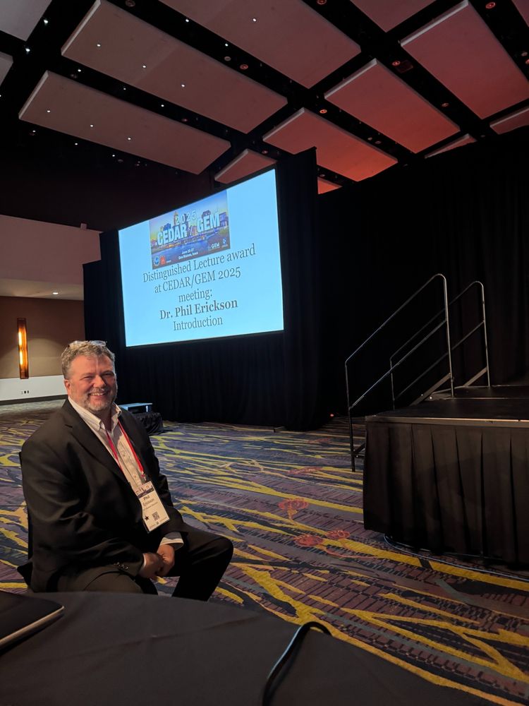 A man sitting in front of a slide for the Distinguished Lecture at CEDAR/GEM 2025
