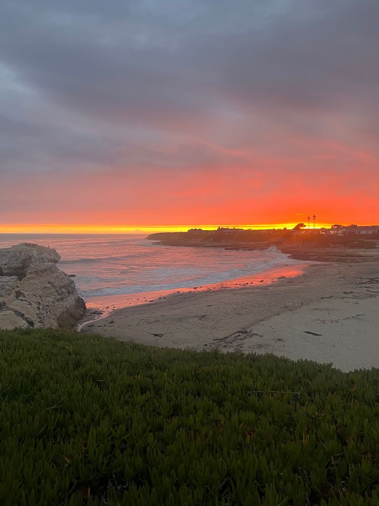 The exact moment of the sunset over natural bridges beach in Santa Cruz