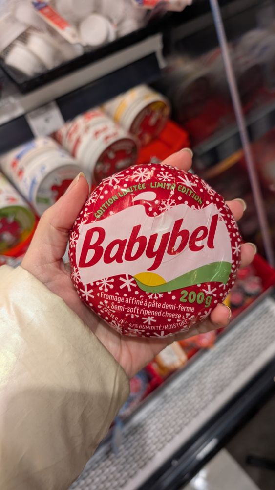 A huge babybel in someone's hand. given that babybels are normally small, like maybe an inch in diameter, this one - which is more like, uhhh, 8 inches, I don't know, I'm not good at guessing sizes - makes the viewer assume that the hand is tiny. 

Sabrina Carpenter is a five foot nothing popstar who loves going on about how itty bitty teeny tiny she is