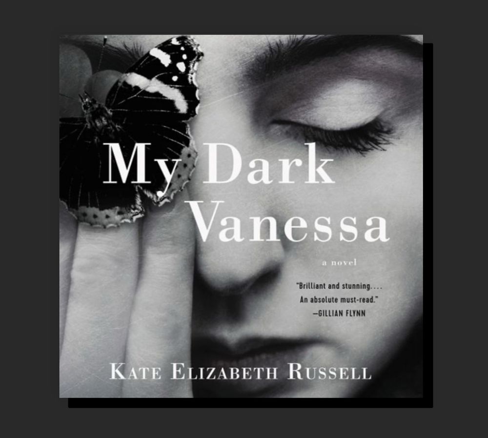 Book cover of ‘My Dark Vanessa’ by Kate Elizabeth Russell. The black-and-white image shows a close-up of a young woman’s face with her eyes closed. A butterfly rests on her fingers, partially covering one eye. The title ‘My Dark Vanessa’ is overlaid in white text, with a quote from Gillian Flynn praising the novel. The author’s name appears at the bottom.