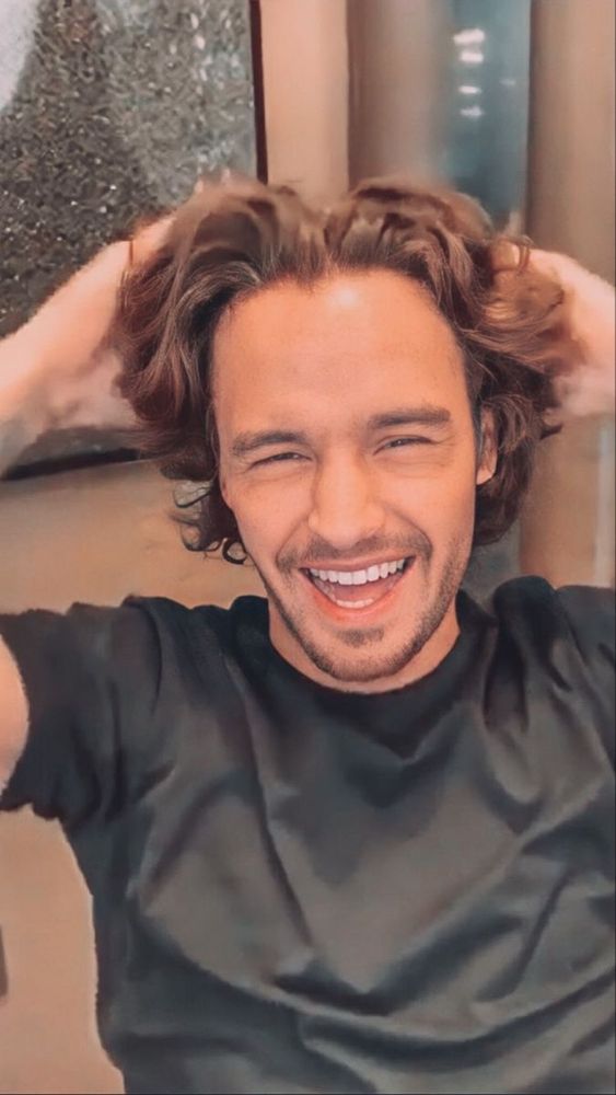 Liam Payne during a live stream laughing and ruffling his hair