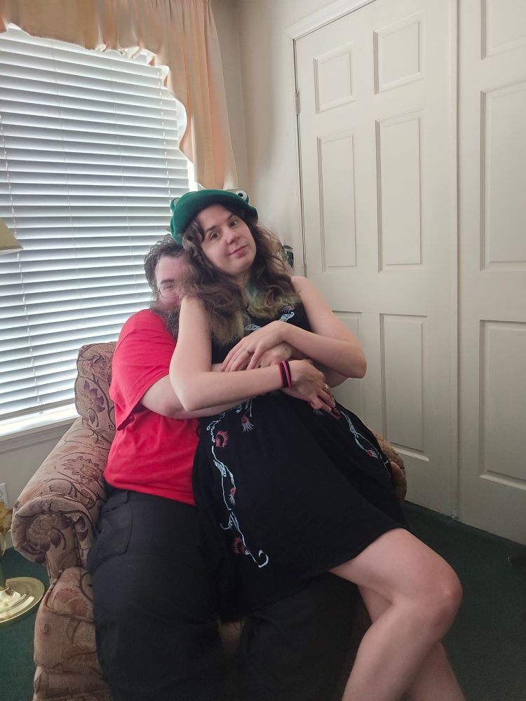 Jax sits on her husband's lap