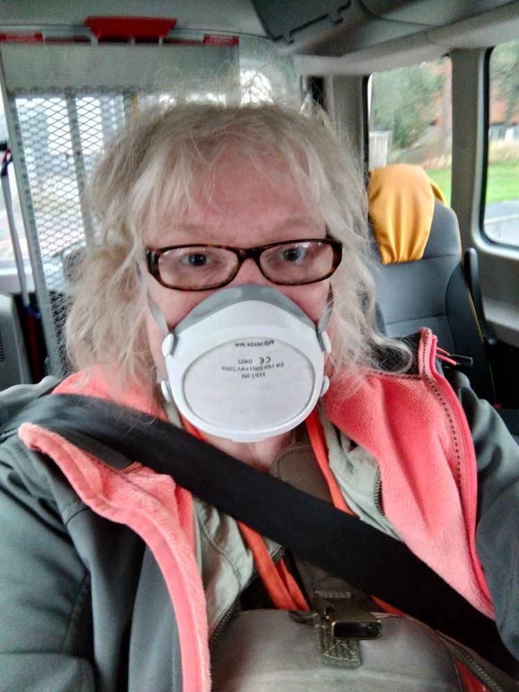 Older white woman in wheelchair wearing a Flo-mask