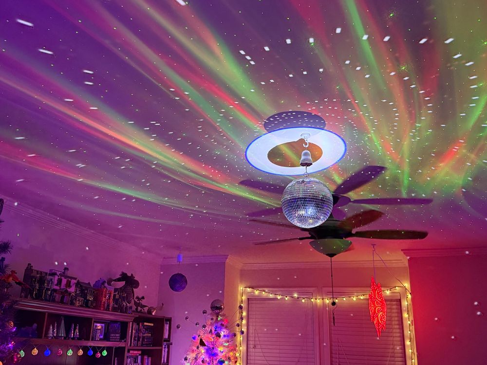 Awesome party lighting on the ceiling of a living room.