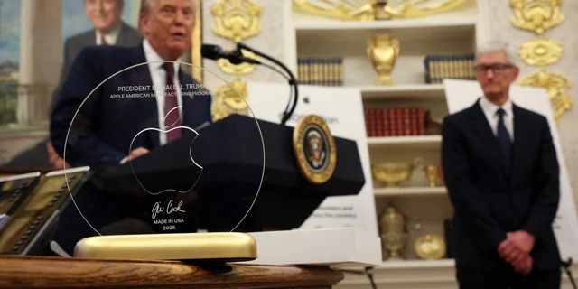 Trump and Tim Cook with an Apple plaque/gold bar thingy