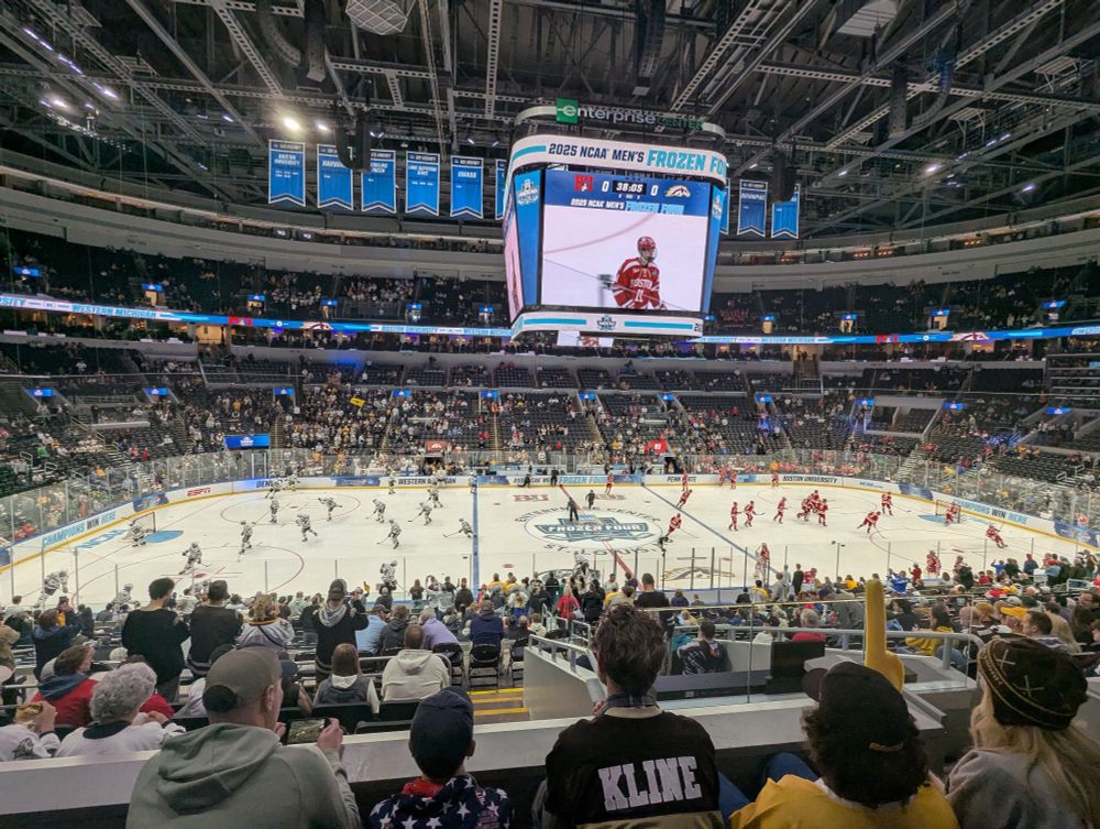 Western Michigan (white jerseys) and Boston University (red jerseys) warming up at the Enterprise Center.