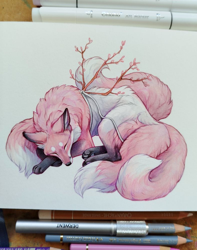 Sketchbook page drawing of a sleeping pink fox with four tails and budding cherry branches sprouting from its back. Drawn with marker pens and colour pencils