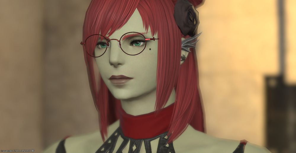 A female Roegadyn with green skin, red hair and bright green eyes.