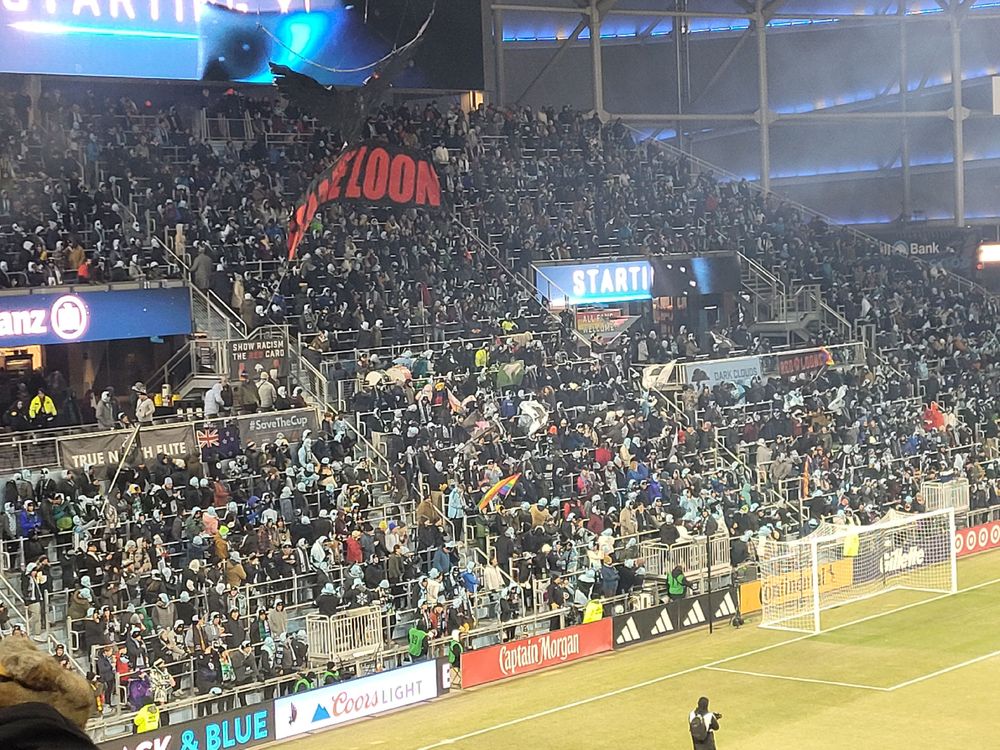 Supporters stand with large Loon tifo