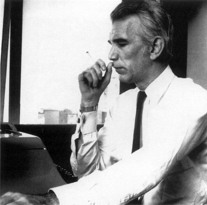 David Whitaker sits at his typewriter, chain-smoking
