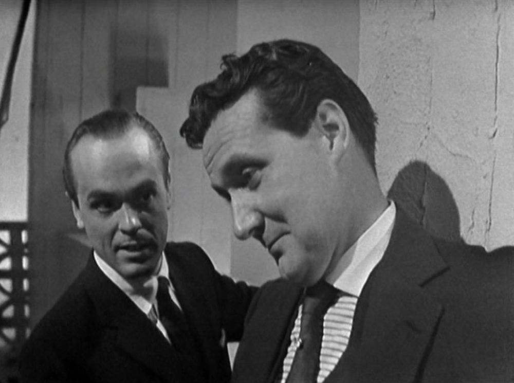 Old pros Stepan (Philip Madoc) and Steed (Patrick Macnee) trade hints of secrets