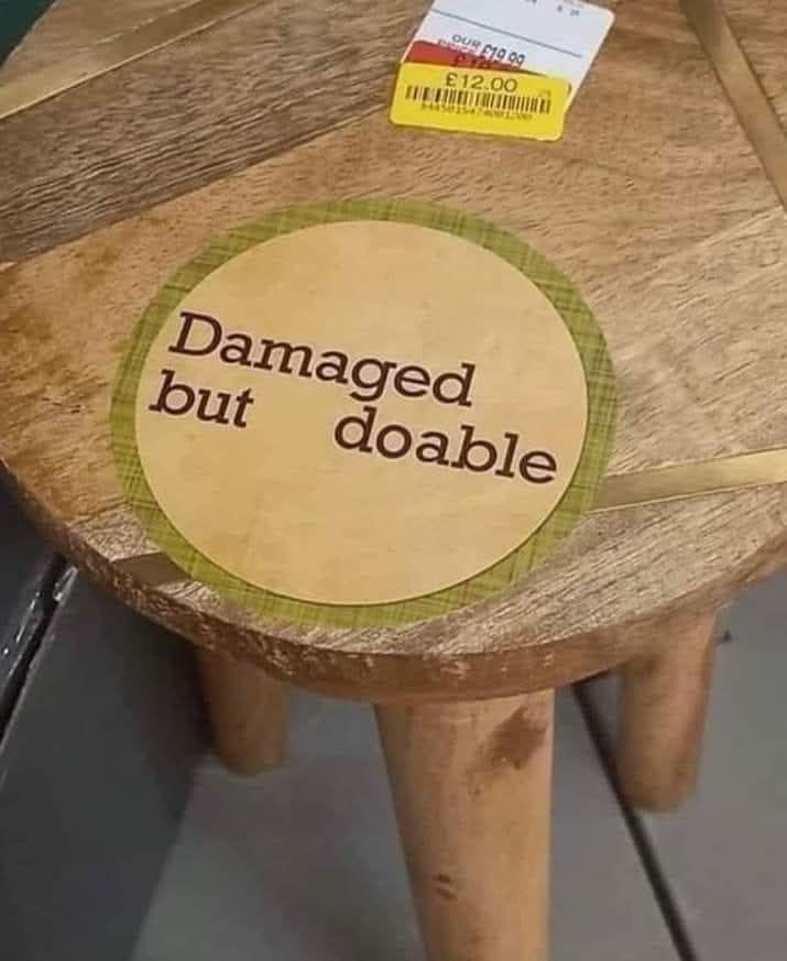 Sign on a small table in a second hand store: damaged but doable