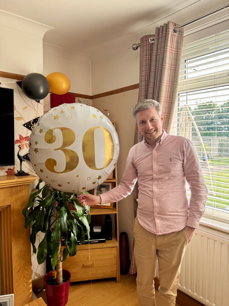 A picture of me holding a 30 ballon 
