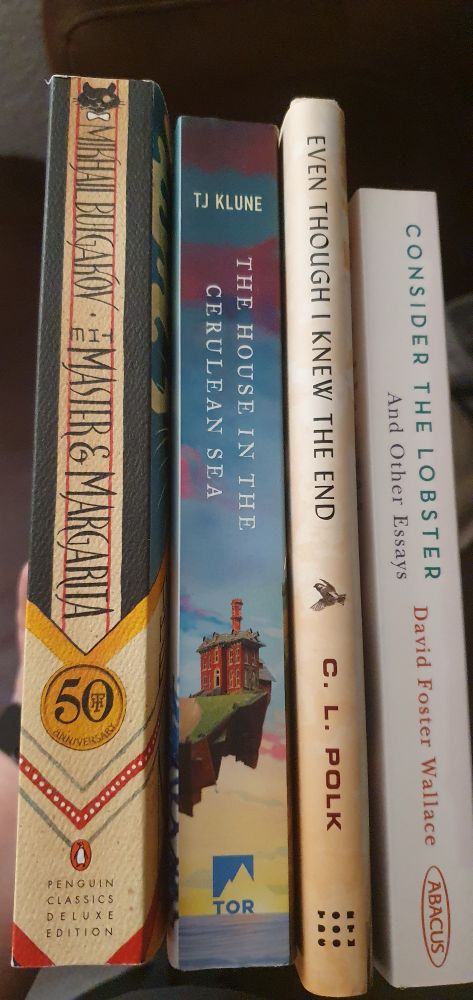A picture of four book spines; left to right: "The Master and Margarita", "The House in the Cerulean Sea", "Even though I knew the End" and Consider the Lobster"