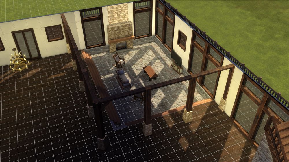 picture of the living room in the sims 4 build. it features a sunken down space with couches, tv, and fireplace. there are many floor to ceiling windows, as well as stone and wooden pillars around the space to create archways