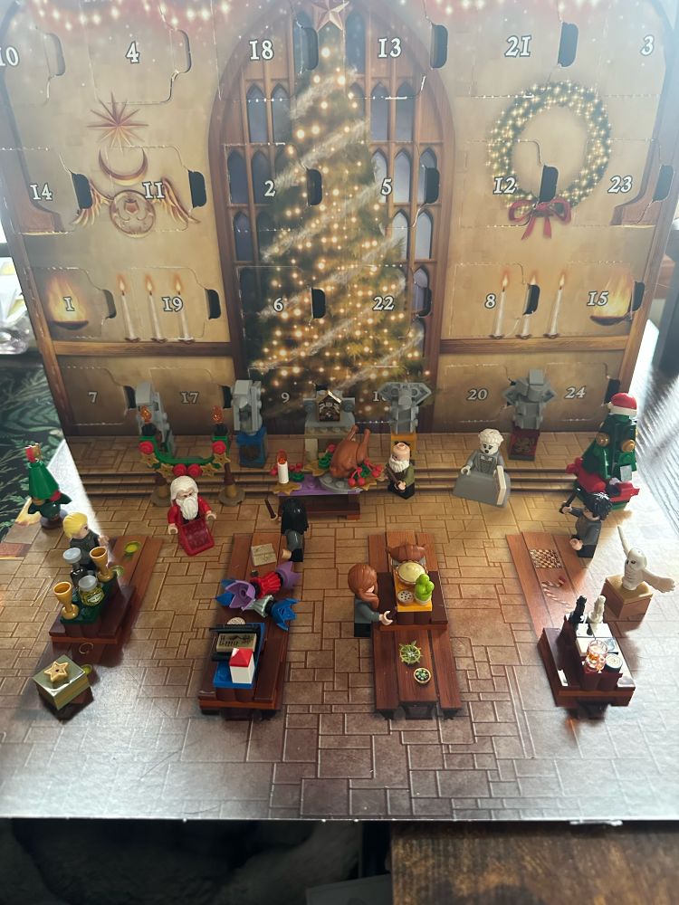 all of the lego harry potter advent calendar builds set up on the box scene of the great hall
