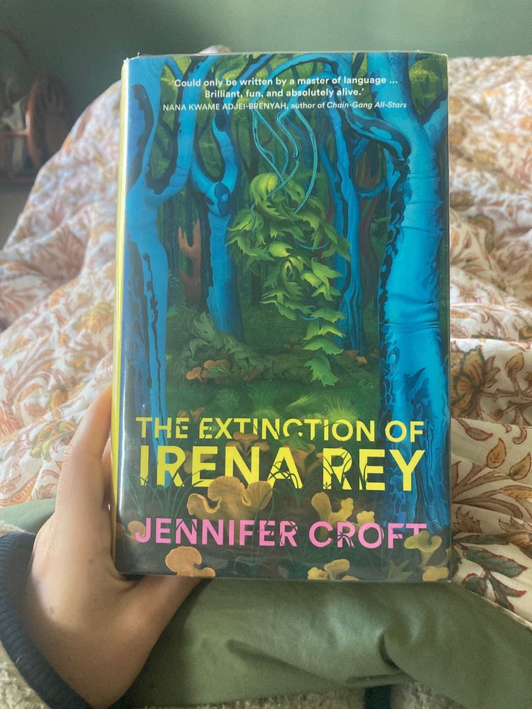 Copy of ‘The Extinction of Irena Rey’ by Jennifer Croft with an orange floral quilt in the background.