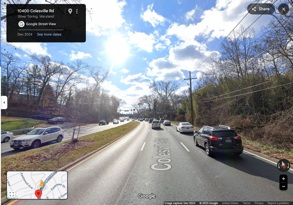 Google Streetview of a six-lane divided road, approaching a traffic signal.