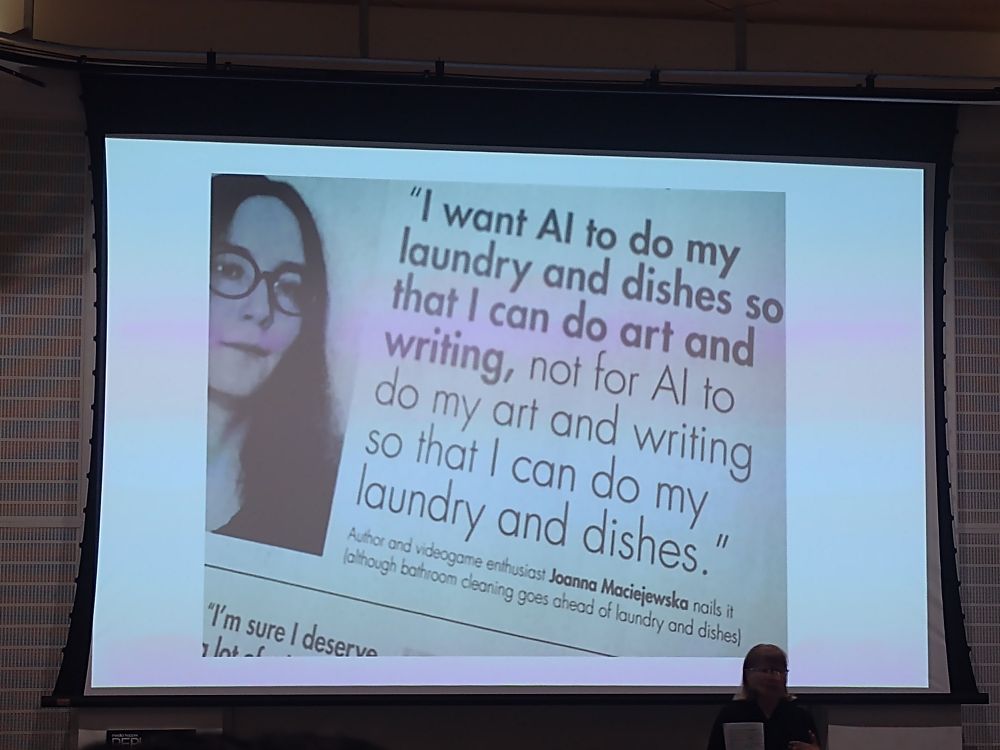 STS scholar Judy Wajcman in front of slide with a quote by Joanne Mackiejewska which says "I want AI to do my dishes so that I can do art and writing, not for AI to do my art and writing so that I can do my laundry and dishes."