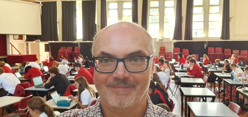 100 students in the school hall doing the KSF with someone taking a selfie in front of them