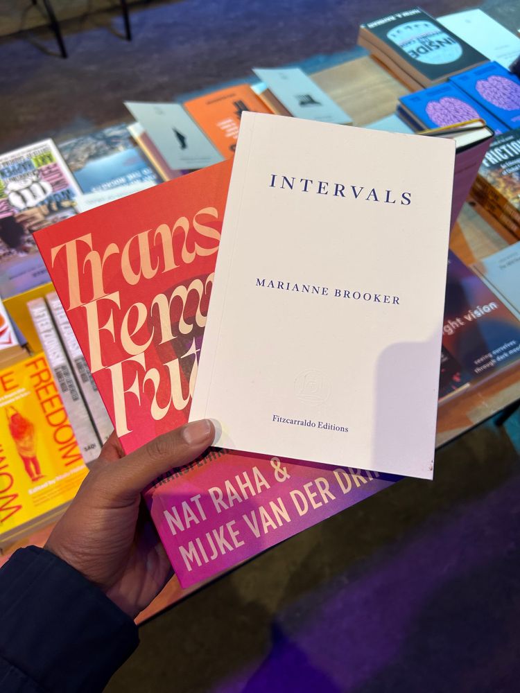 The covers of Trans Femme Futures and Intervals. Intervals is all white with blue text.  Trans Femme Futures is pink and orange.